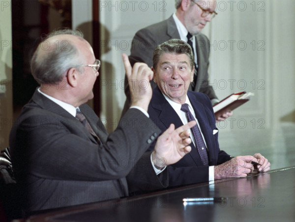 U.S. President Ronald Reagan and Soviet General Secretary Mikhail Gorbachev during signing of INF Treaty, White House East Room, Washington, D.C., USA, President Ronald Reagan White House Photographic Office, December 8, 1987
