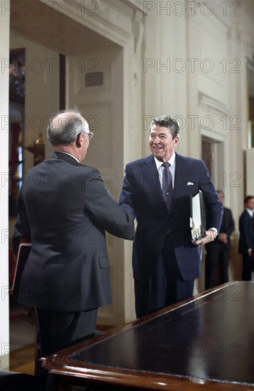 U.S. President Ronald Reagan and Soviet General Secretary Mikhail Gorbachev shaking hands after signing of INF Treaty, White House East Room, Washington, D.C., USA, President Ronald Reagan White House Photographic Office, December 8, 1987