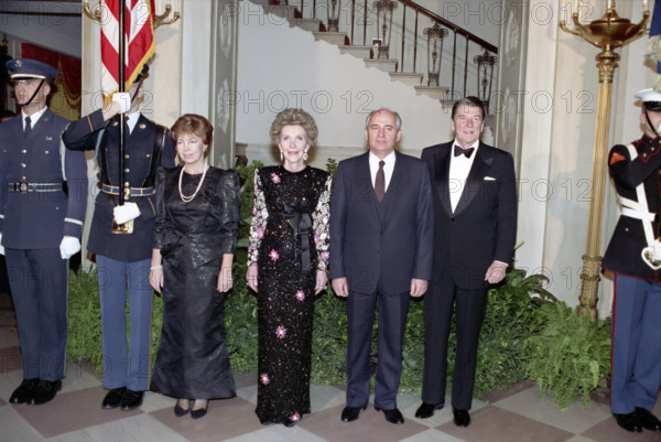 First Lady of the Soviet Union Raisa Gorbachev, U.S. First Lady Nancy Reagan, Soviet General Secretary Mikhail Gorbachev and U.S. President Ronald Reagan in White House Cross Hall before State Dinner, Washington, D.C., USA, President Ronald Reagan White House Photographic Office, December 8, 1987