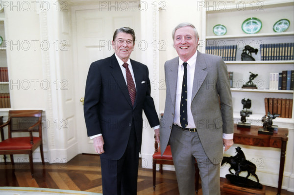 U.S. President Ronald Reagan meeting with William F Buckley in White House Oval Office, Washington, D.C., USA, President Ronald Reagan White House Photographic Office, January 21, 1988