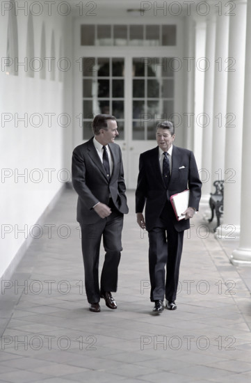 U.S. President Ronald Reagan and U.S. Vice President George H.W. Bush walking along White House Colonnade, Washington, D.C., USA, President Ronald Reagan White House Photographic Office, May 3, 1988