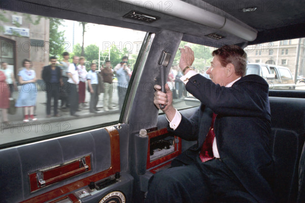 U.S. President Ronald Reagan waving to citizens while Driving in his limousine from Moscow State University to Spaso House, Moscow, Russia, USSR, President Ronald Reagan White House Photographic Office, May 31, 1988