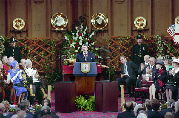 U.S. President Ronald Reagan giving speech to members of The Royal Institute of International Affairs, British Prime Minister Margaret Thatcher and U.S. First Lady looking on at right, Guildhall, London, England, UK, President Ronald Reagan White House Photographic Office, June 2, 1988