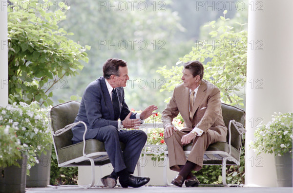 U.S. President Ronald Reagan and U.S. Vice President George H.W. Bush having discussion on the White House Colonnade, Washington, D.C., USA, President Ronald Reagan White House Photographic Office, July 7, 1988