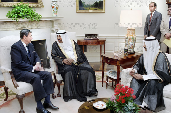 U.S. President Ronald Reagan during working visit of Prime Minister Saad Al-Abdullah Al-Salim Al-Sabah (center) and Crown Prince Jaber Al-Ahmad Al-Sabah (right) of Kuwait, White House Oval Office, Washington, D.C., USA, President Ronald Reagan White House Photographic Office, July 12, 1988
