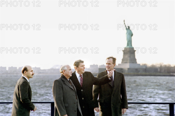 U.S. President Ronald Reagan and U.S. Vice President/U.S. President-elect George H.W. Bush with Soviet General Secretary Mikhail Gorbachev, Governors Island with Statue of Liberty in background, New York City, New York, USA, President Ronald Reagan White House Photographic Office, December 7, 1988