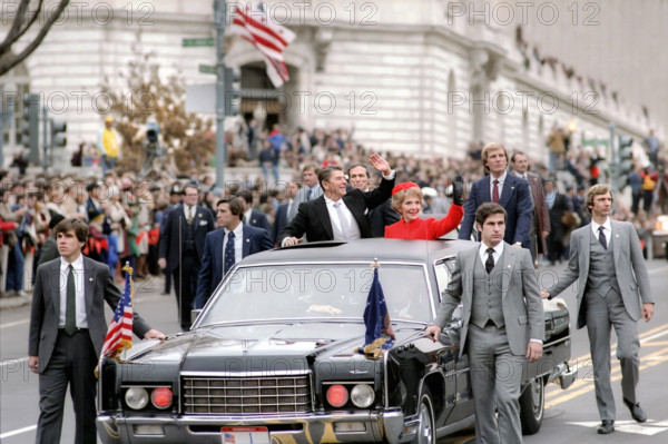 U.S. President Ronald Reagan and U.S. First Lady Nancy Reagan waving from presidential limousine during Inaugural Parade, Washington, D.C., USA, President Ronald Reagan White House Photographic Office, January 20, 1981