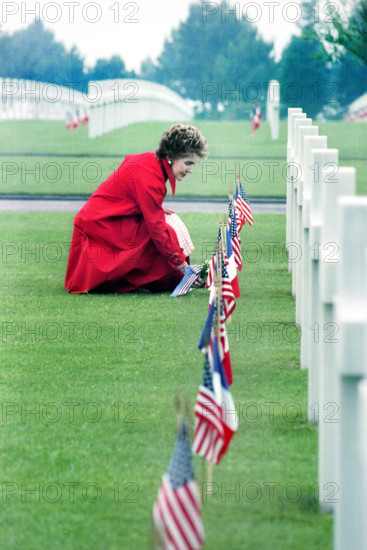 U.S. First Lady Nancy Reagan laying flowers at Omaha Beach Memorial Cemetery, Colleville-sur-Mer, Normandy, France, President Ronald Reagan White House Photographic Office, June 6, 1982