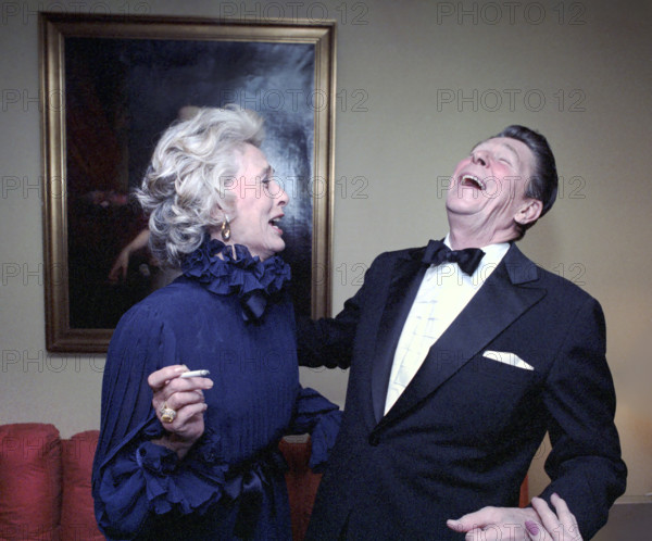 U.S. President Ronald Reagan laughing with American actress Gloria Stewart (and wife of American actor James Stewart), at dinner party, Watergate Hotel, Washington, D.C., USA, President Ronald Reagan White House Photographic Office, February 7, 1981