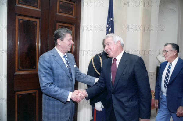 U.S. President Ronald Reagan shaking hands with retired American baseball player Joe DiMaggio at White House baseball hall of fame luncheon, Washington, D.C., USA, President Ronald Reagan White House Photographic Office, March 27, 1981