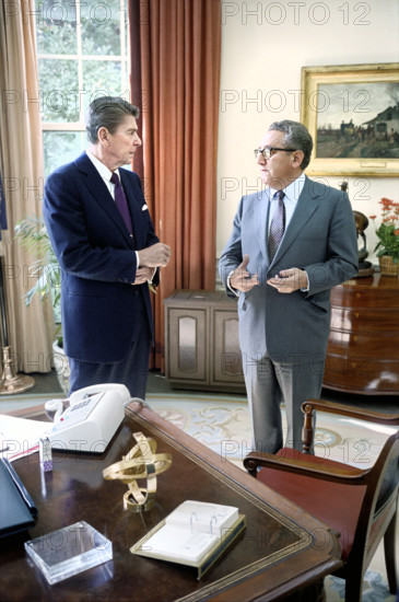 U.S. President Ronald Reagan meeting with former U.S. Secretary of State Henry Kissinger in White House Oval Office, Washington, D.C., USA, President Ronald Reagan White House Photographic Office, October 5, 1981