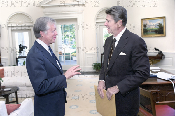 U.S. President Ronald Reagan with former U.S. President Jimmy Carter in the White House Oval Office, Washington, D.C., USA, President Ronald Reagan White House Photographic Office, October 13, 1981
