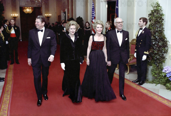 U.S. President Ronald Reagan and U.S. First Lady Nancy Reagan with British Prime Minister Margaret Thatcher and her husband Denis Thatcher arriving at State Dinner for Prime Minister Thatcher, White House, Washington, D.C., USA, President Ronald Reagan White House Photographic Office, February 26, 1981