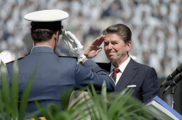 U.S. President Ronald Reagan saluting Air Force cadet at United States Air Force Academy commencement, Colorado Springs, Colorado, USA, President Ronald Reagan White House Photographic Office, May 30, 1984