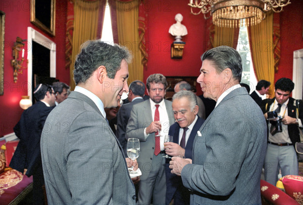 U.S. President Ronald Reagan with Prime Minister Yitzhak Shamir of Israel and with Deputy Chief of Mission at the Embassy of Israel Benjamin Netanyahu during a luncheon in the White House Red Room, Washington, D.C., USA, President Ronald Reagan White House Photographic Office, November 29, 1983