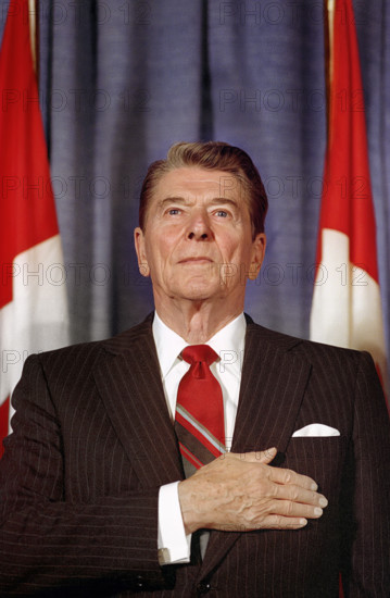 U.S. President Ronald Reagan with his hand over his heart during speech to the Empire Club at G-7 Economic Summit, Royal York Hotel, Toronto, Canada, President Ronald Reagan White House Photographic Office, June 21, 1988