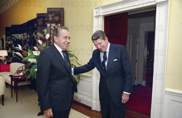 U.S. President Ronald Reagan laughing with former U.S. President Richard Nixon in White House center hall private residence, Washington, D.C., USA, President Ronald Reagan White House Photographic Office, July 28, 1988