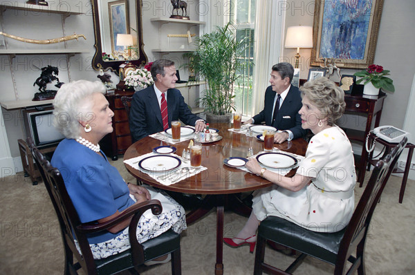 U.S. President Ronald Reagan and U.S. First Lady Nancy Reagan having lunch with U.S. Vice President George H.W. Bush and U.S. Second Lady Barbara Bush in White House Oval Office study, Washington, D.C., USA, President Ronald Reagan White House Photographic Office, August 11, 1988