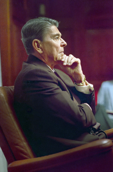 U.S. President Ronald Reagan sitting during a National Security Planning Group (NSPG) meeting in the White House, Situation Room, Washington, D.C., USA, President Ronald Reagan White House Photographic Office, August 12, 1988