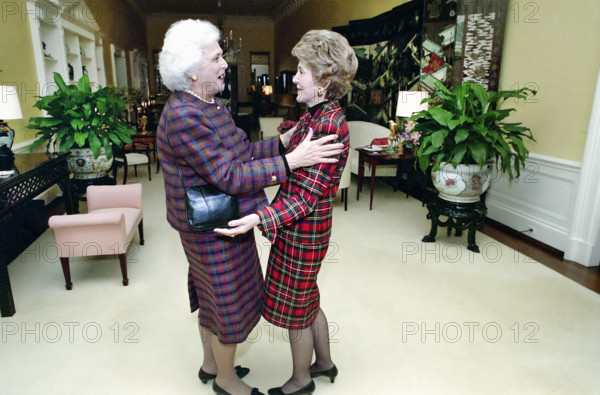 U.S. First Lady Nancy Reagan greeting U.S. Second Lady Barbara Bush in the White House private residence Center Hall before tea meeting, Washington, D.C., USA, President Ronald Reagan White House Photographic Office, January 11, 1989