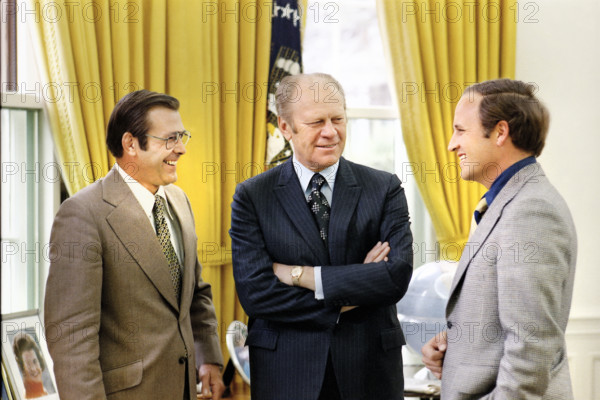 U.S. President Gerald R. Ford chatting with Chief of Staff Donald Rumsfeld and Rumsfeld’s Assistant Richard Cheney in the White House Oval Office, Washington, D.C., USA, Gerald R. Ford White House Photographs, April 28, 1974