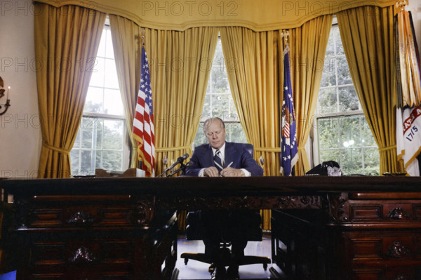 U.S. President Gerald R. Ford signing proclamation granting pardon to former U.S. President Richard Nixon, White House Oval Office, Washington, D.C., USA, Gerald R. Ford White House Photographs, September 8, 1974