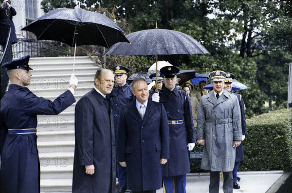 U.S. military guards holding umbrellas over U.S. President Gerald R. Ford and Prime Minister Yitzhak Rabin of Israel during the arrival ceremony for the Prime Minister's state visit, White House, Washington, D.C., USA, Gerald R. Ford White House Photographs, January 27, 1976