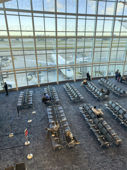 High angle view of travelers relaxing in departure lounge, Delta Airlines, Fort Lauderdale-Hollywood International Airport, Fort Lauderdale, Florida, USA