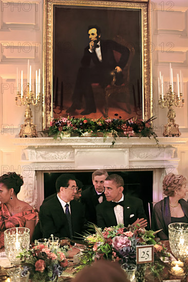 U.S. President Barack Obama and U.S. First Lady Michelle Obama sit with President Hu Jintao of China under a portrait of Abraham Lincoln during State Dinner in White House State Dining Room, Washington, D.C., USA, Pete Souza, Office of White House Photography Office, January 19, 2011