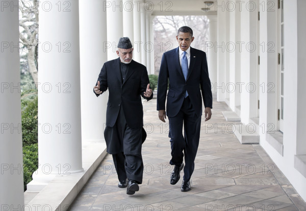 U.S. President Barack Obama and President Hamid Karzai of Afghanistan walking along White House Colonnade following their meeting in the Oval Office, Washington, D.C., USA, Pete Souza, Office of White House Photography, January 11, 2013