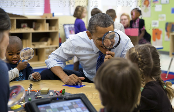 U.S. President Barack Obama playing magnifying glass game with children during a visit to a pre-kindergarten classroom at the College Heights Early Childhood Learning Center, Decatur, Georgia, USA, Pete Souza, Office of White House Photography, February 14, 2013