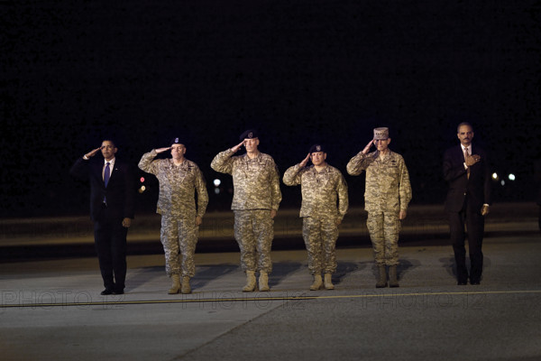 U.S. President Barack Obama and U.S. Attorney General Eric Holder attending ceremony for the dignified transfer of 18 U.S. personnel who died in Afghanistan, Dover Air Force Base, Dover, Delaware, USA, Pete Souza, Office of White House Photography Office, October 29, 2009