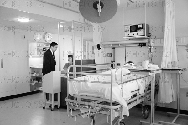 Patient in bed and staff in hospital room, Morris Cafritz Memorial Hospital, Washington, D.C., USA, Thomas J. O'Halloran, U.S. News & World Report Magazine Photograph Collection, January 9, 1967