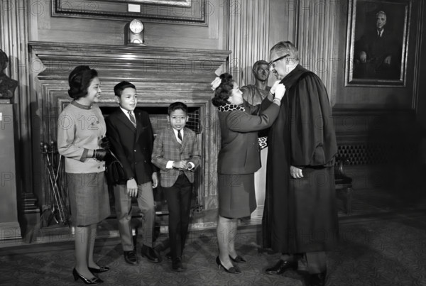 Thurgood Marshall, Associate Justice of the U.S. Supreme Court, assisted with his robes by his wife Cecilia Suyat Marshall, with his family (left to right) sister-in-law Sally Aroba and sons Thurgood Jr. and John, Washington, D.C., USA, Marion S. Trikosko, U.S. News & World Report Magazine Photograph Collection, October 2, 1967