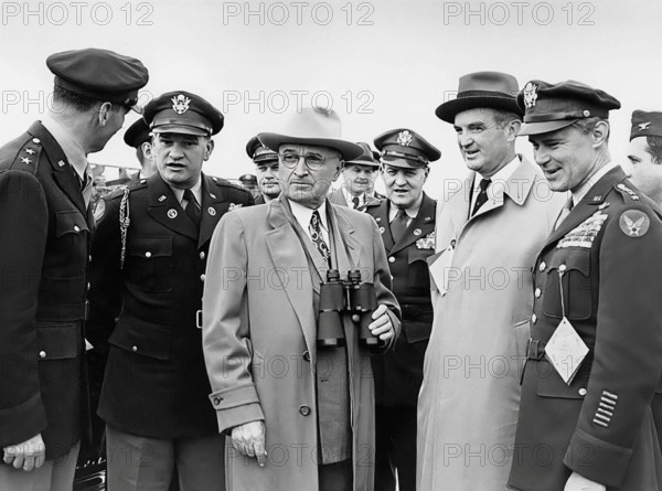 U.S. President Harry S. Truman (center, with binoculars) attending Air Progress Demonstration. From left: U.S. General Laurence Kuter, U.S. General Robert B. Landry, President Truman, U.S. General Harry H. Vaughan, U.S. Secretary Stuart Symington, and U.S. General Hoyt Vandenberg, Andrews Air Force Base, Prince George's County, Maryland, USA, Abbie Rowe, National Parks Service, Harry S. Truman Library, February 15, 1949