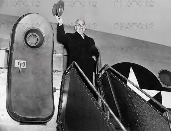 President Harry S. Truman waving his hat from door of his airplane, "Sacred Cow" as he prepares to leave for Christmas trip home to Independence, Missouri, USA, National Airport, Washington, D.C., USA, Abbie Rowe, National Parks Service, Harry S. Truman Library, December 25, 1945