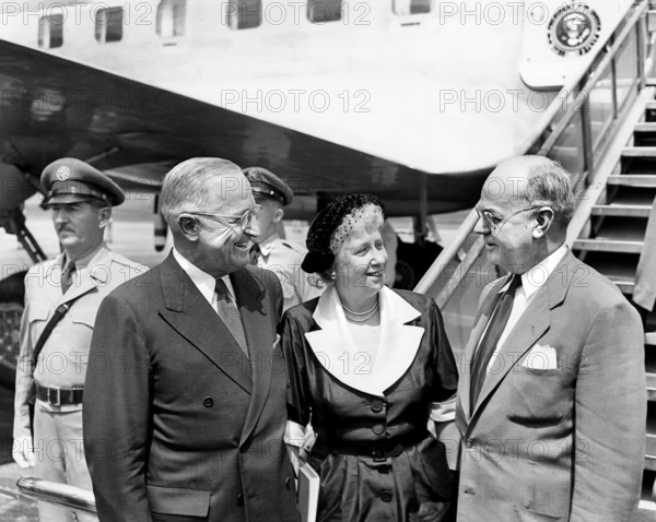U.S. President Harry S. Truman (left) and U.S. First Lady Bess W. Truman (center) speak with Treasury Secretary John Snyder (right) as they prepare to depart for Chicago, Illinois to attend the Democratic National Convention, National Airport, Washington, D.C., USA, Abbie Rowe, National Parks Service, Harry S. Truman Library, July 25, 1952