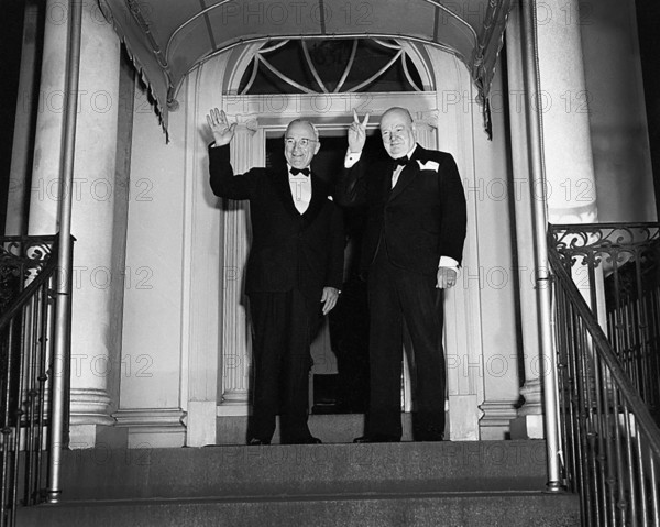 British Prime Minister Winston Churchill (right) flashing his "V for Victory" sign and U.S. President Harry S. Truman (left) waving outside Blair House, Washington, D.C., USA, Abbie Rowe, National Parks Service, Harry S. Truman Library, March 24, 1949