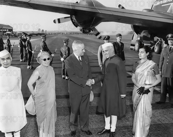 U.S. President Harry S. Truman (third from left) greeting Prime Minister of India Jawaharlal Nehru (foreground, second from right), Nehru's sister, Madame Pandit (second from left) and his daughter, Indira Gandhi (foreground, right) upon their arrival at Washington National Airport, Washington, D.C., USA, Abbie Rowe, National Parks Service, Harry S. Truman Library, October 11, 1949