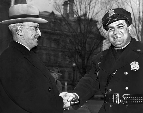 U.S. President Harry S. Truman shaking hands with an unidentified police officer while attending dedication ceremony at George Washington National Masonic Memorial, Alexandria, Virginia, USA, Abbie Rowe, National Parks Service, Harry S. Truman Library, February 22, 1950