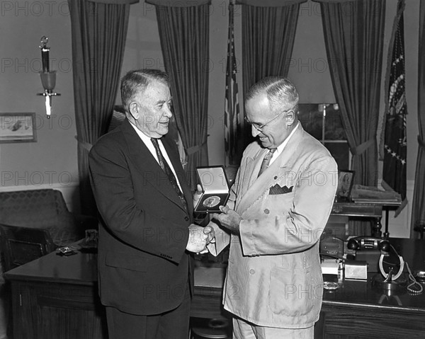 President Harry S. Truman (right) presents a Congressional Gold Medal, authorized by Congress, to U.S. Vice President Alben Barkley, White House Oval Office, Washington, D.C., USA, Abbie Rowe, National Parks Service, Harry S. Truman Library, June 2, 1950