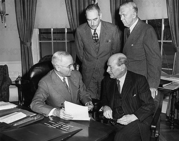 British Prime Minister Clement Attlee (seated right) meeting with President Harry S. Truman (seated left), U.S. Secretary of State Dean Acheson (standing left) and U.S. Secretary of Defense George C. Marshall (standing right) in White House Oval Office, Washington, D.C., USA, Abbie Rowe, National Parks Service, Harry S. Truman Library, December 4, 1950