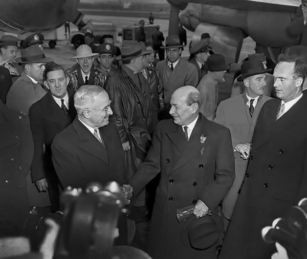 U.S. President Harry S. Truman (foreground, left) greeting British Prime Minister Clement Attlee (foreground, right) at Washington National Airport, upon Attlee's arrival for talks on the Korean crisis, Washington, D.C., USA, Abbie Rowe, National Parks Service, Harry S. Truman Library, December 4, 1950