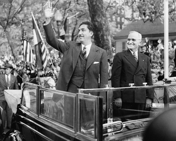 Mexican President Miguel Aleman (left) waving to crowd as U.S. President Harry S. Truman (right) looks on from an open limousine during welcoming ceremonies and parade in Aleman's honor, Washington, D.C., USA, Abbie Rowe, National Parks Service, Harry S. Truman Library, April 29, 1947