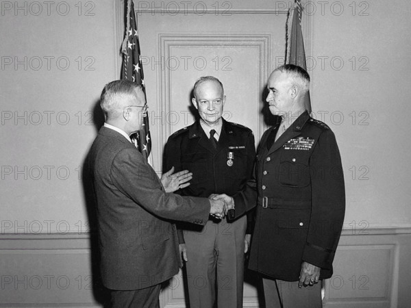 U.S. President Harry S. Truman (left) shaking hands with U.S. General Omar Bradley (right), who had been sworn in as Chief of Staff of the U. S. Army, as U'S General Dwight D. Eisenhowe looks on, Pentagon, Arlington, Virginia, USA, Abbie Rowe, National Parks Service, Harry S. Truman Library, February 7, 1948