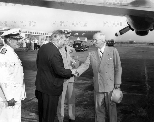 U.S. President Harry S. Truman shaking hands with Brazilian Ambassador Carlos Martins as they prepare to board the presidential airplane for a flight to Brazil, Washington National Airport, Washington, D.C., USA, Abbie Rowe, National Parks Service, Harry S. Truman Library, August 31, 1947