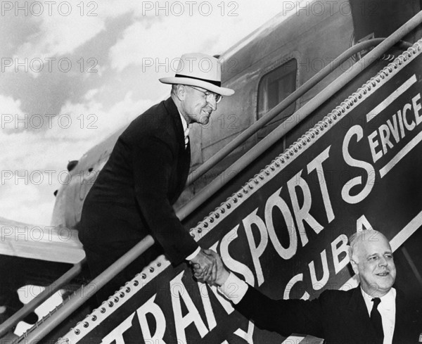 U.S. President Harry S. Truman shaking hands with White House doorkeeper William Simmons as he descends the airplane stairs upon his return from his Florida vacation, Washington National Airport, Washington, D. C., USA, Abbie Rowe, National Parks Service, Harry S. Truman Library, March 5, 1948