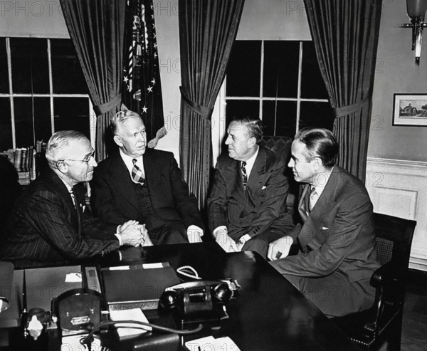 U.S. President Harry S. Truman, Secretary of State George C. Marshall, Economic Cooperation Administrator Paul Hoffman, and Ambassador Averell Harriman discussing Marshall Plan White House Oval Office, Washington DC, USA, Abbie Rowe, National Parks Service, Harry S. Truman Library, November 29, 1948