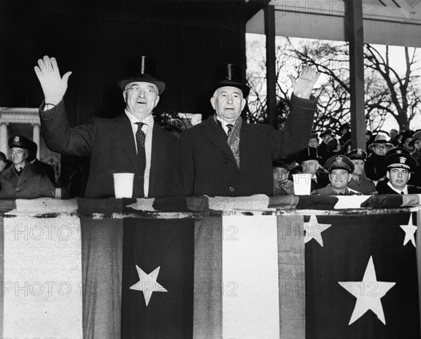 U.S. President Harry S. Truman (left) and U.S. Vice-President Alben Barkley (right) waving from reviewing stand during Inaugural Parade, Washington, D.C., USA, Abbie Rowe, National Parks Service, Harry S. Truman Library, January 20, 1949