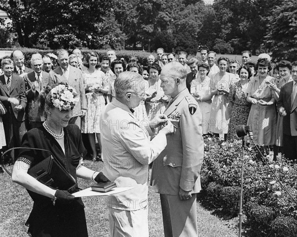 U.S. President Harry S. Truman (center) pinning Distinguished Service Medal on U.S. General Dwight D. Eisenhower while the General's wife Mamie Eisenhower (left) looks on, Washington, D.C., USA, Abbie Rowe, National Parks Service, Harry S. Truman Library, June 18, 1945